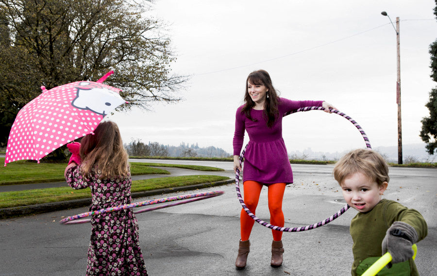 A family enjoying the Big and Little Hoop set during backyard play.
