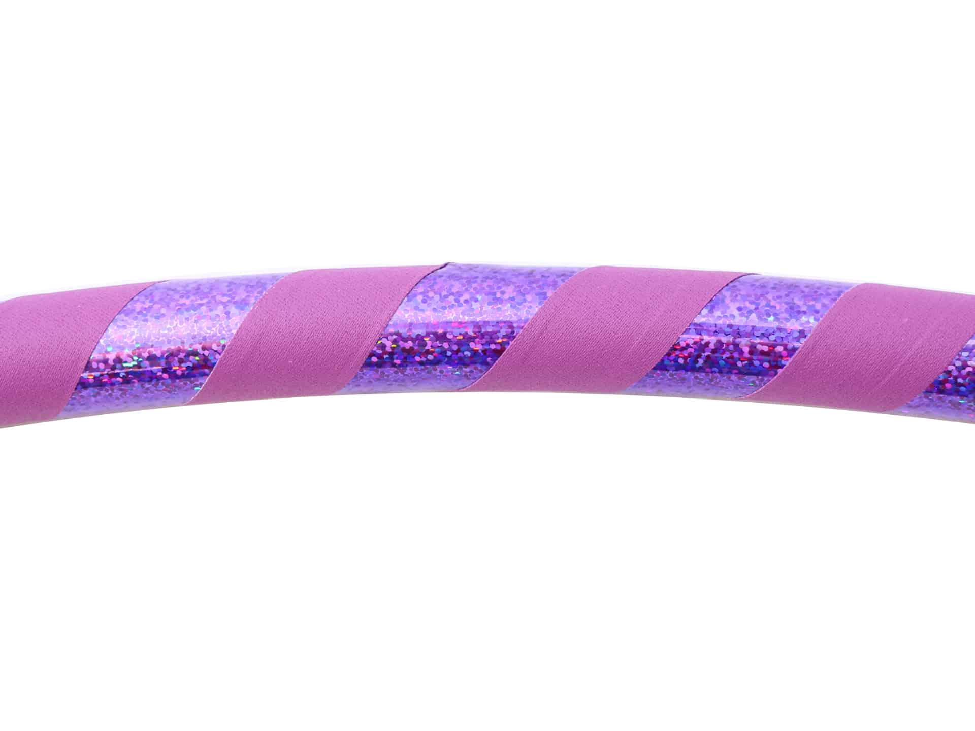purple hula hoop with sparkle glitter sequin tape on a white background. healthy activity. fitness. exercise. holistic lifestyle. 