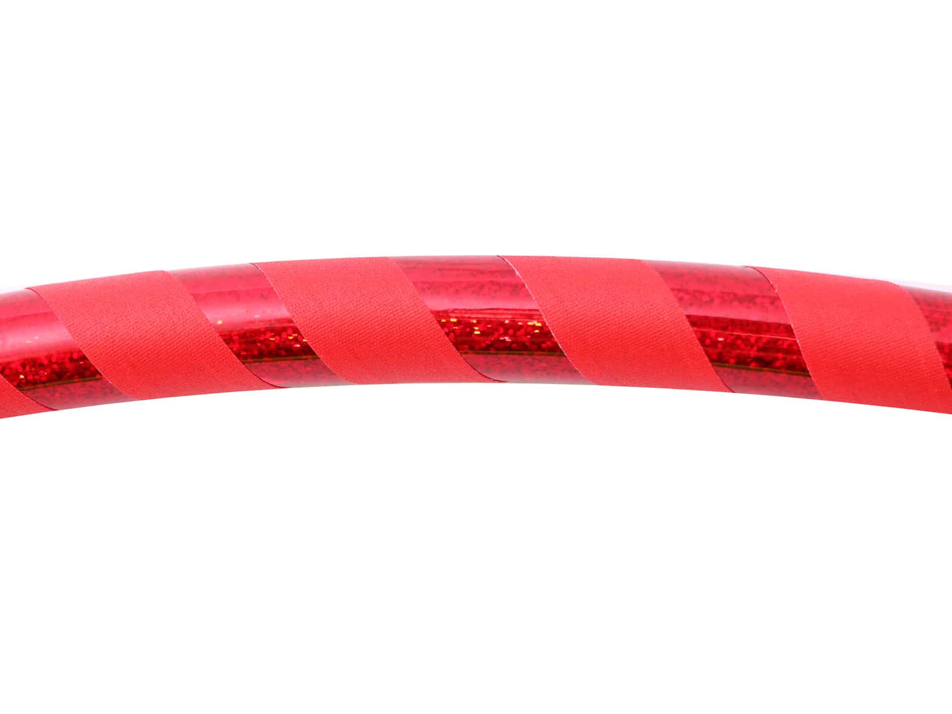 Red hula hoop with sequin tape on a white background. great gift for families. exercise, fitness, outdoor activity