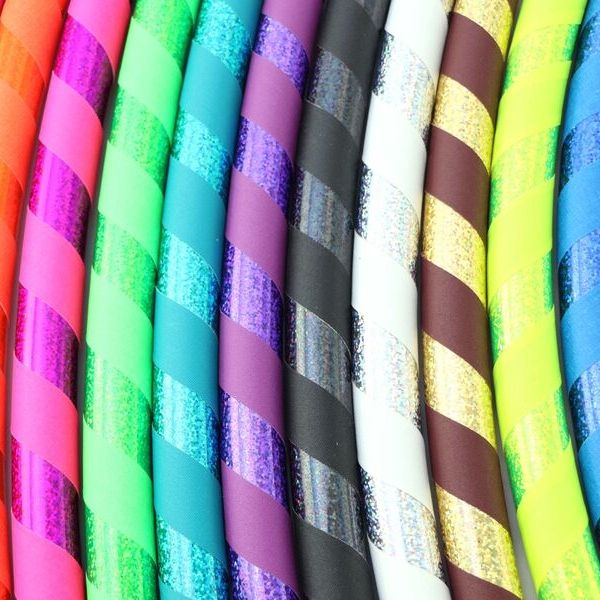 A collection of fitness hoops in various colors with a sequin design. family hula hoop bundle - outdoor activity, exercise, fitness